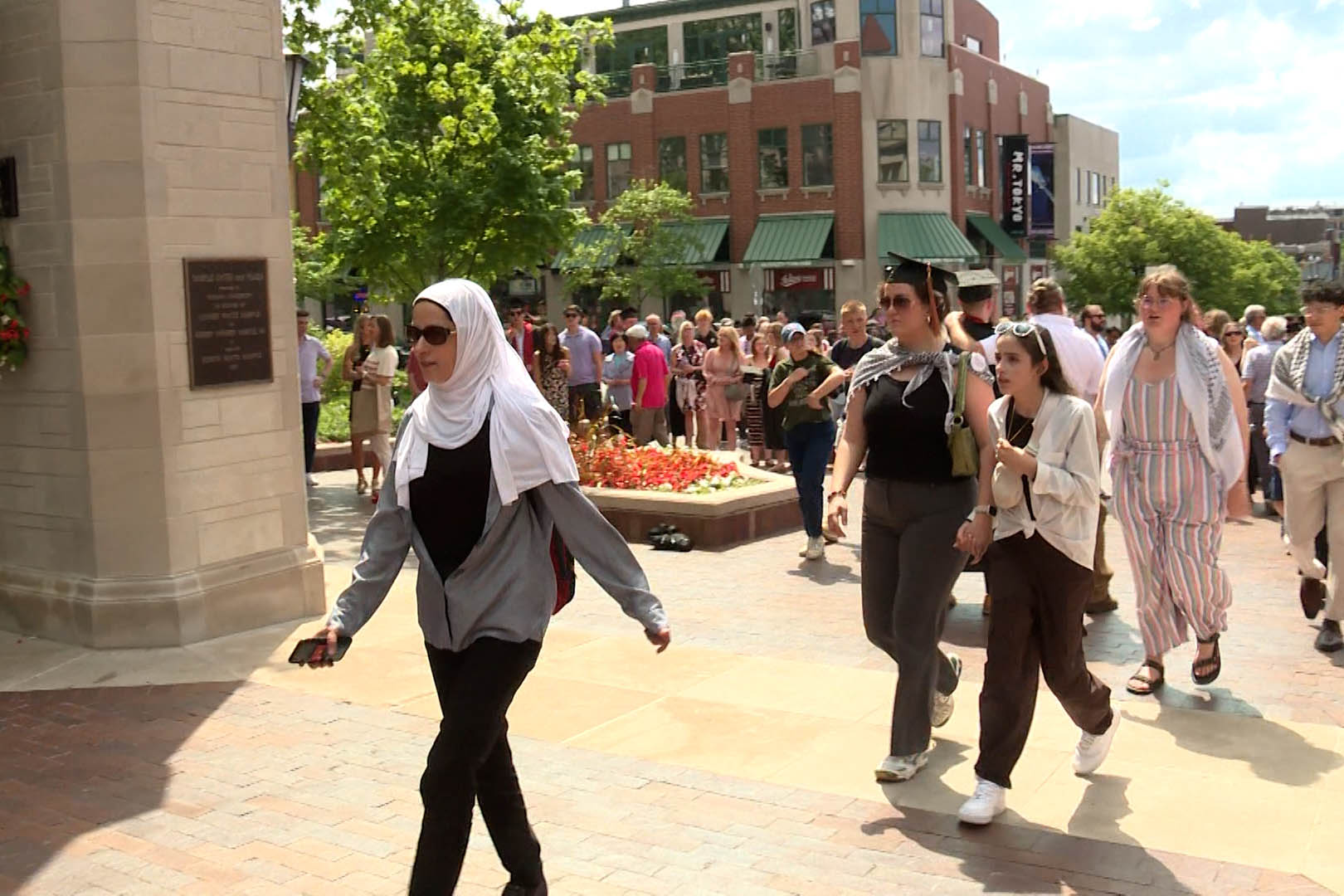 Protesters march through Sample Gates Saturday.