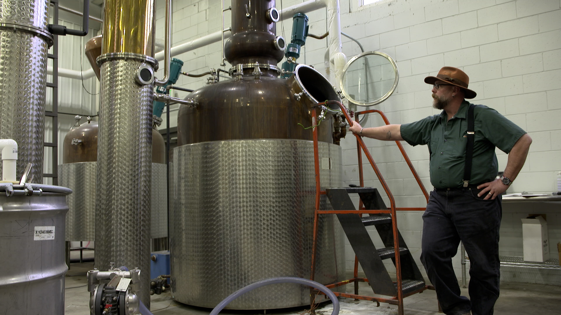 distiller leans against still
