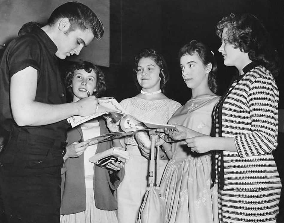 Elvis signing autographs