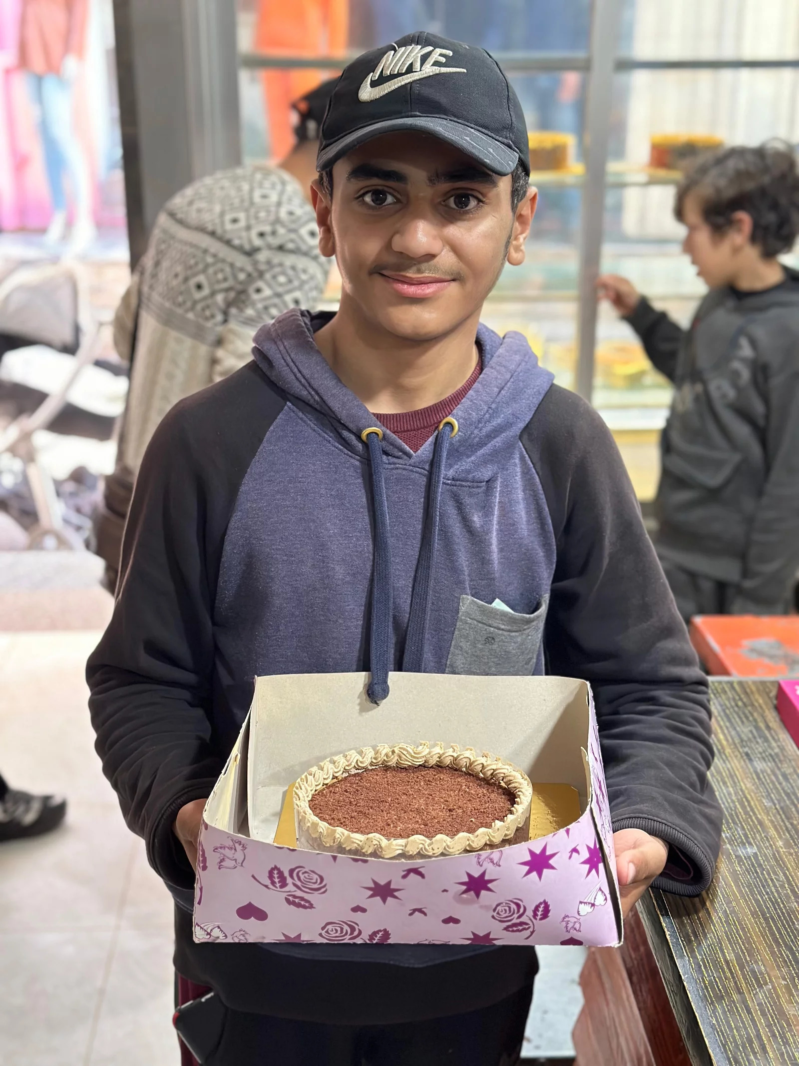 boy holding cake box