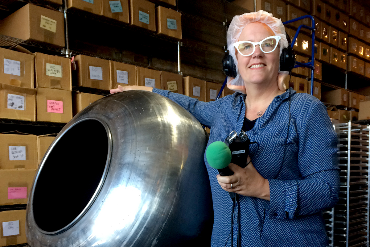 Kayte Young, with recording equipment and a hairnet,  standing next to a round metal machine