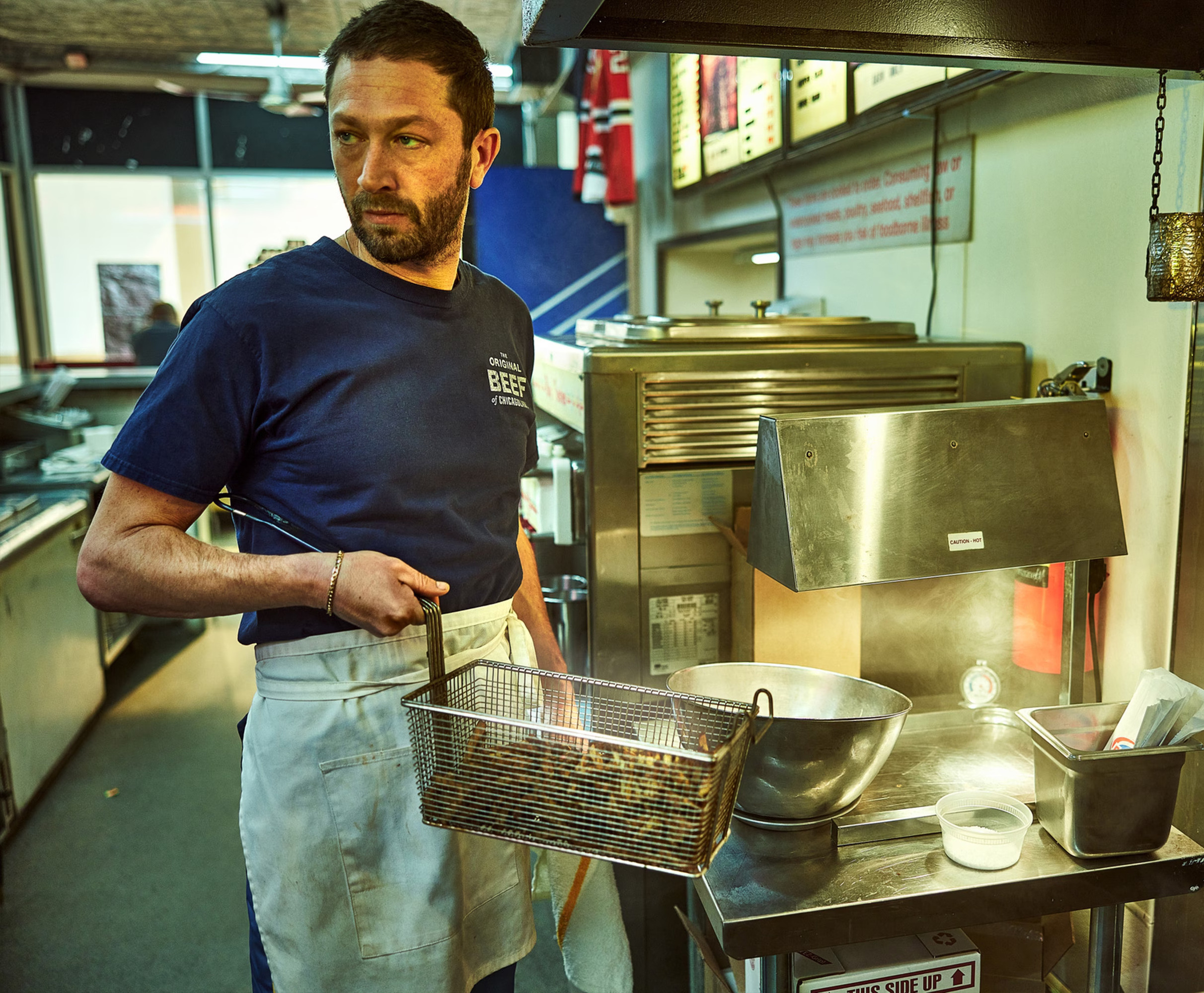 Richie Jerimovich poses in kitchen with deep fryer basket in his hand