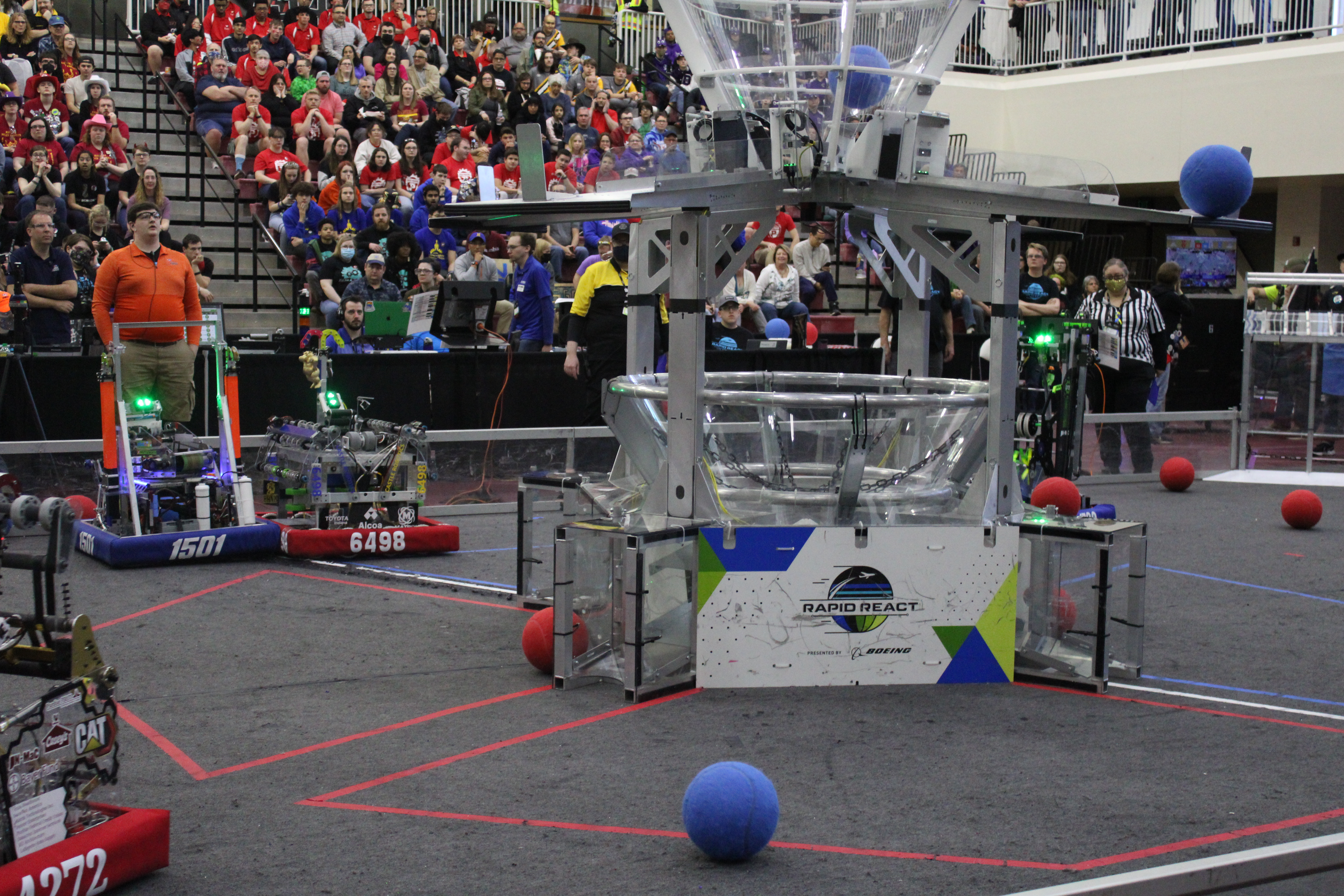 Robots compete to shoot balls in the hoop