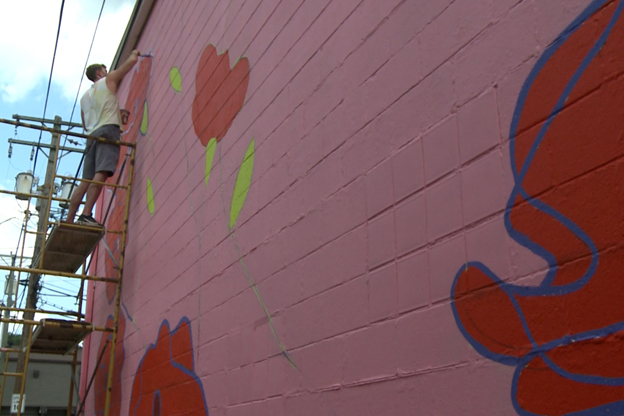 A new mural is being painted in an alley off Main Street in Nashville.