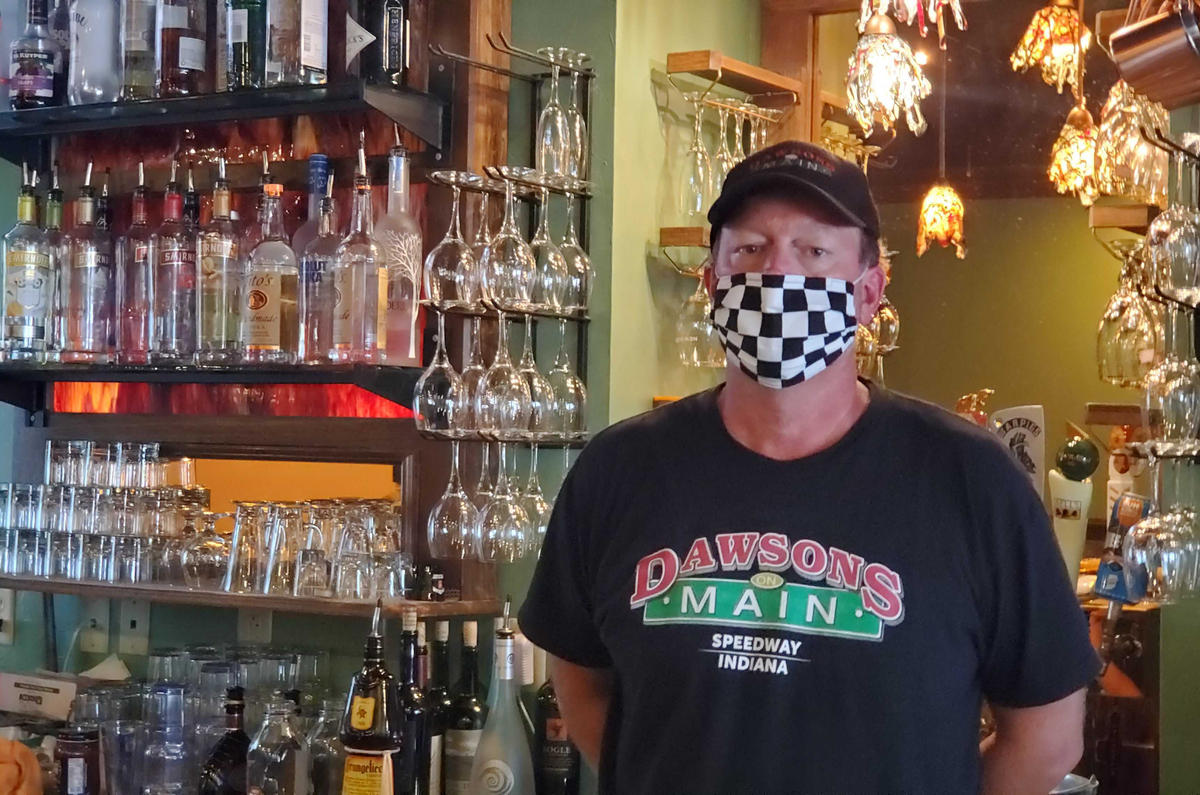 Dawson’s On Main co-owner Chris Hill stands behind the bar at his restaurant just a short walk from the Indianapolis Motor Speedway.