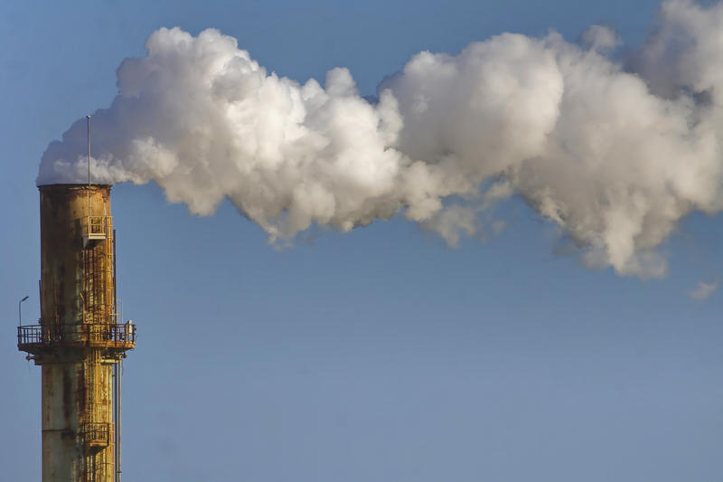 A stock image of smokestacks.