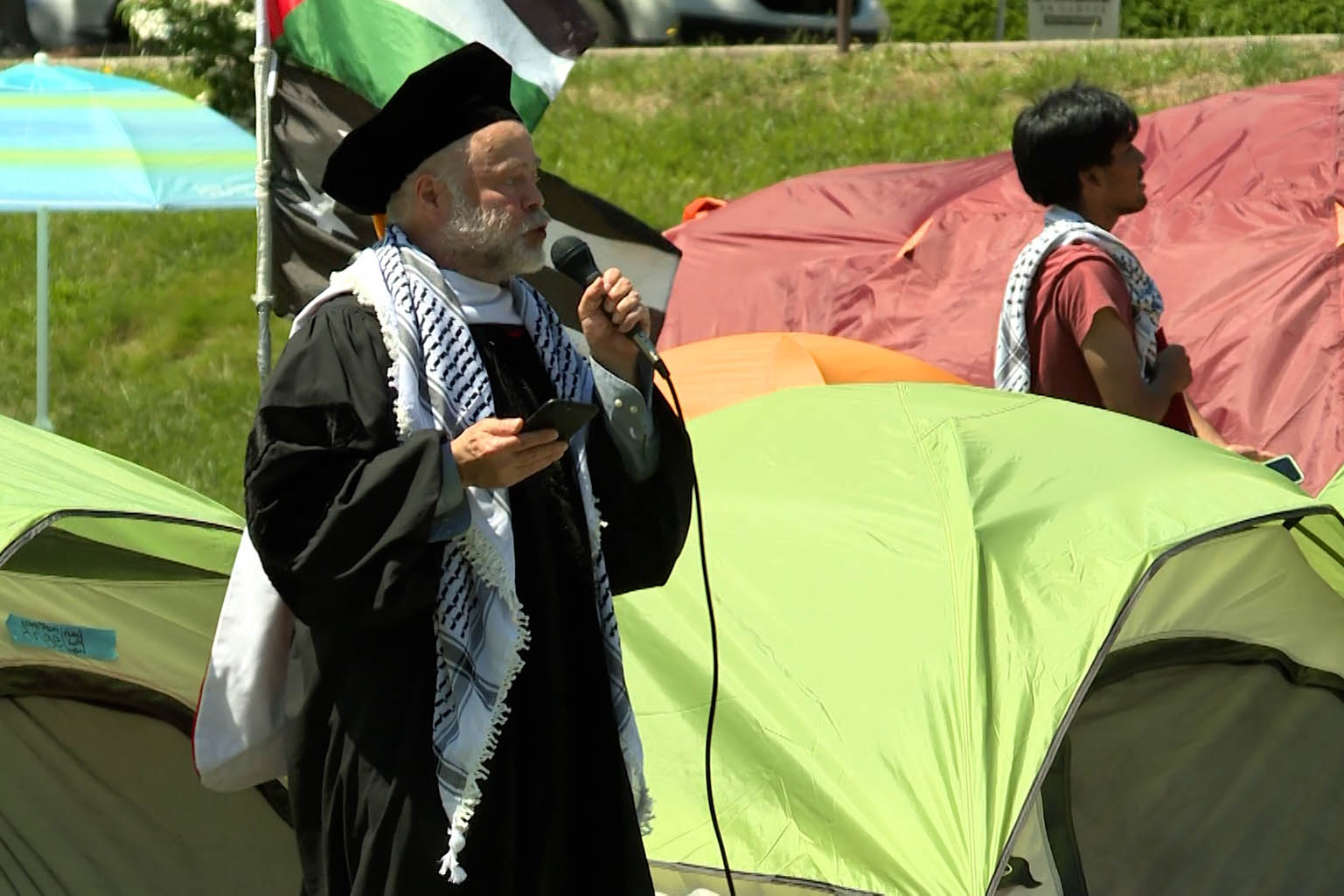 IU professor Ben Robinson speaks in Dunn Meadow Saturday during what was billed as an alternative commencement.