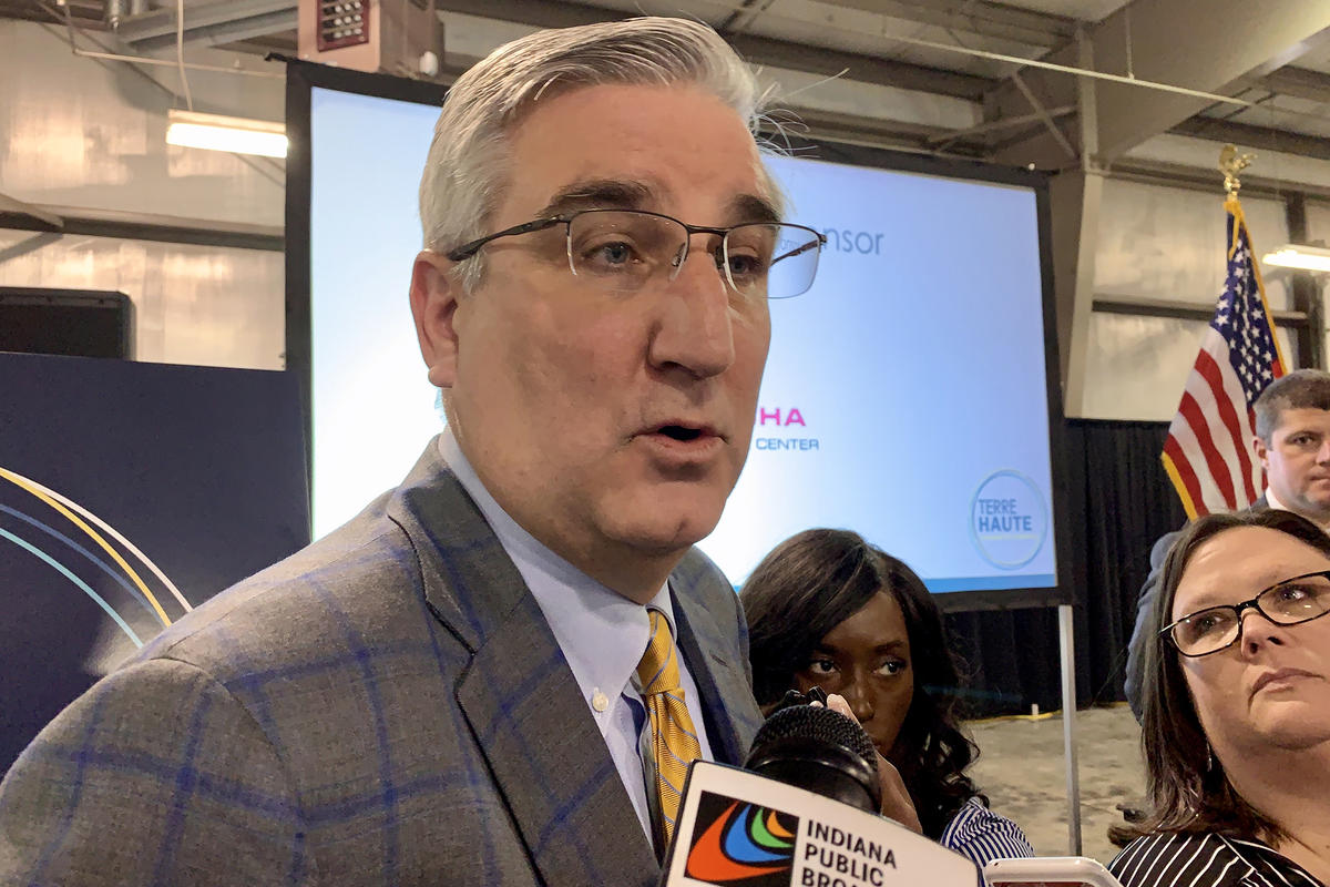 Gov. Eric Holcomb speaks at a podium.