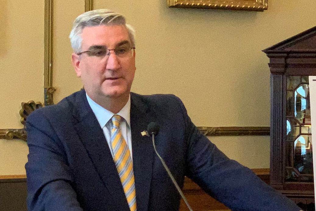 Gov. Eric Holcomb speaks at a podium.