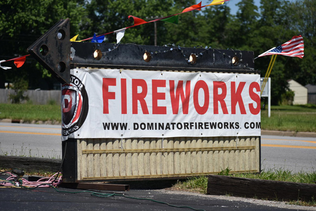 A man browsing the shelves of a fireworks store.
