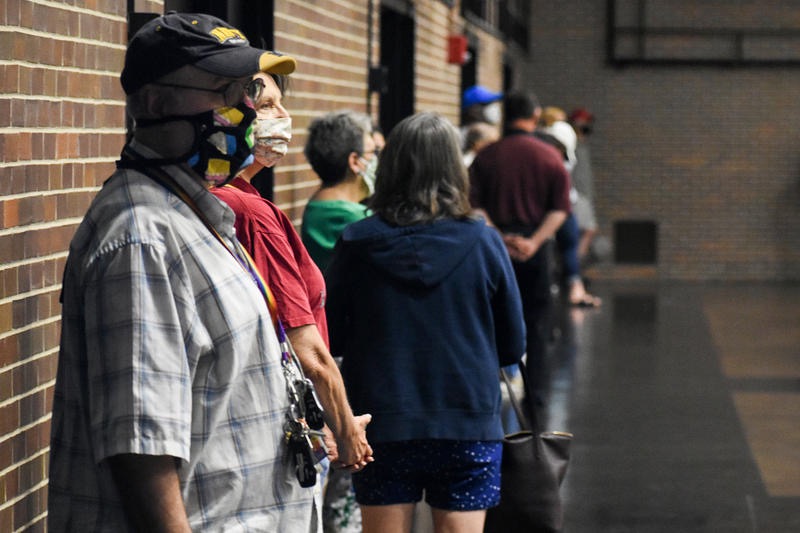 Worker stands at a COVID-19 testing center at IU Bloomington on Sunday, Aug. 9, 2020.