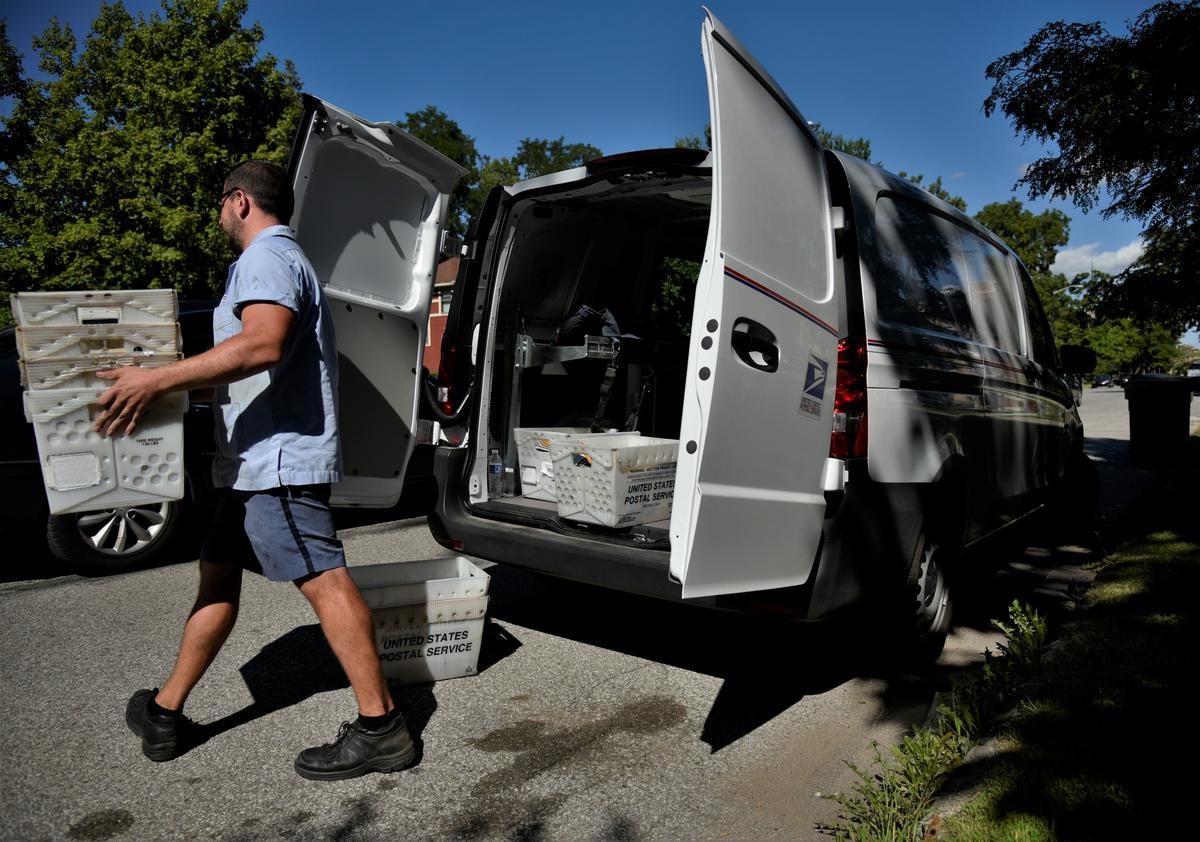 A postal worker in South Bend delivering mail.