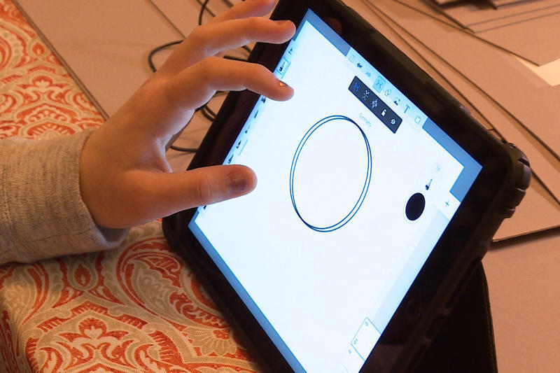 kid drawing on ipad