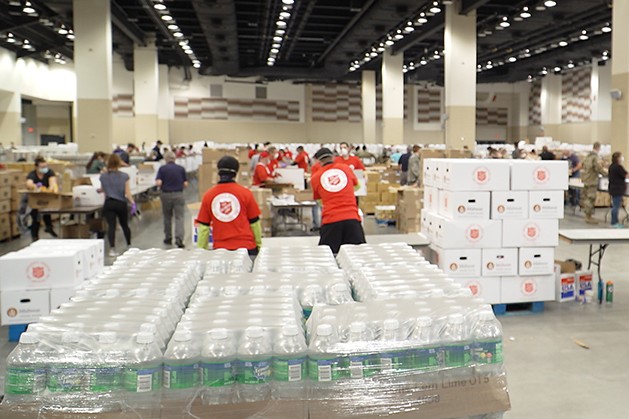 Volunteers from the Salvation Army, Midwest Food Bank, The Indiana National Guard and Lucas Oil Stadium pack food boxes.