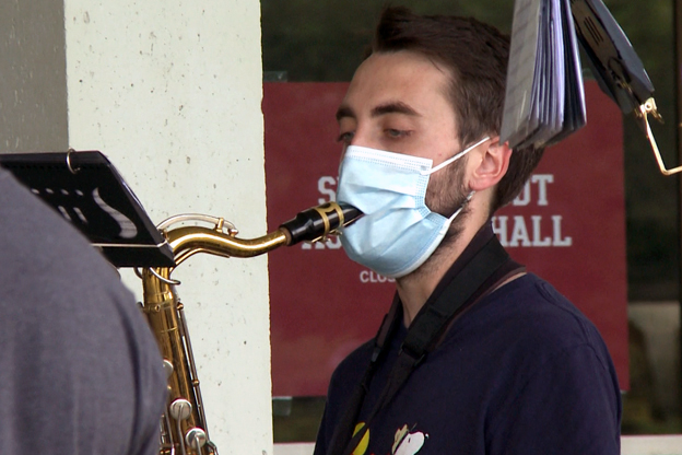 Marching Hundred member wears mask with slit