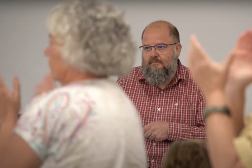 Vigo and Vermillion County inhabitants applaud following an emotional speech by fellow resident Susan Strole-Kos at an August meeting. Company executive Rory Chambers looks on.