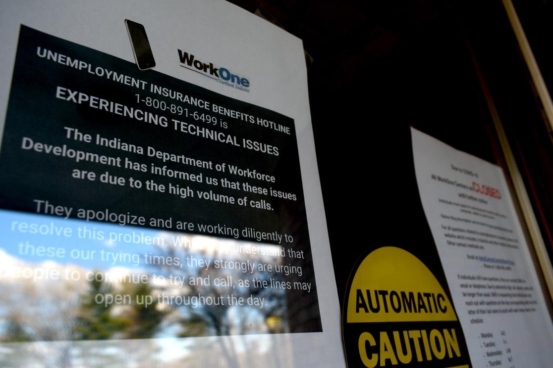 A sign informs visitors that while WorkOne employment offices are closed, the Department of Workforce Development is experiencing technical issues due to high call volumes.