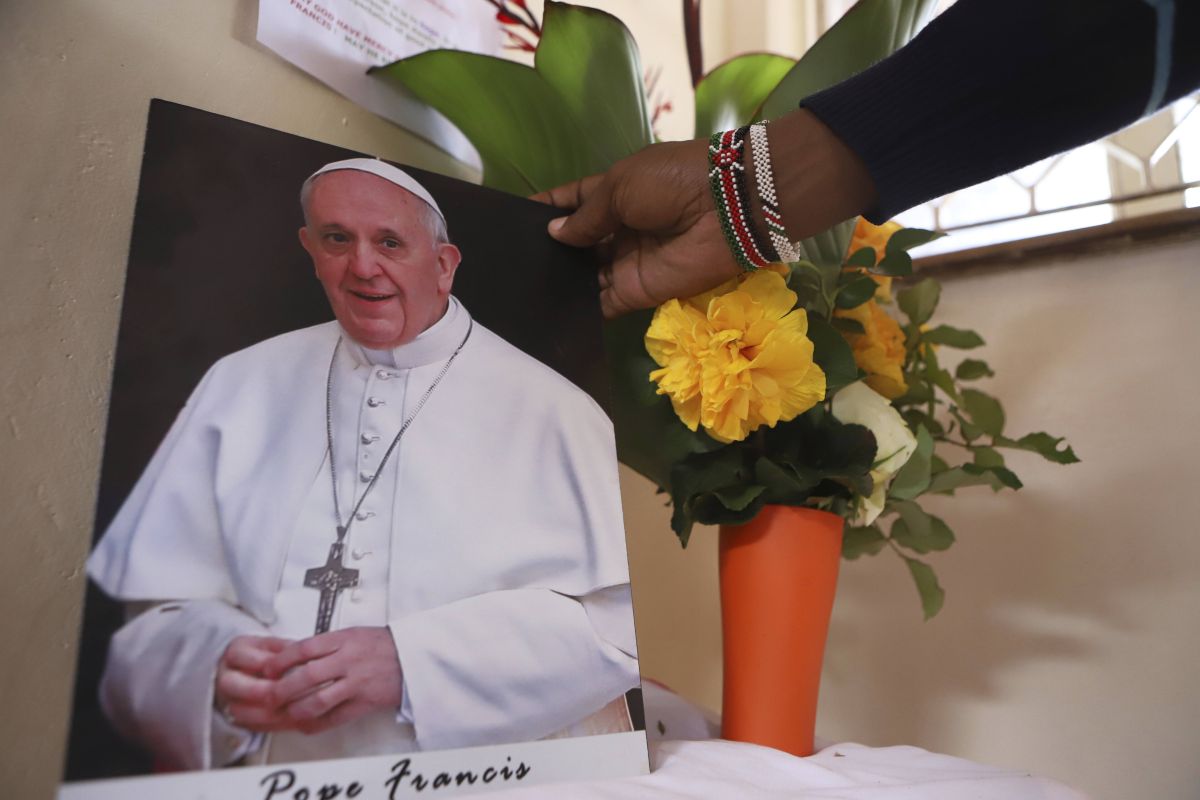 AP OK - A woman holds a photo of the late Pope Francis at the Holy Family Basilica Church in downtown Nairobi, Kenya, Tuesday, April 22, 2025. (AP Photo/Andrew Kasuku)