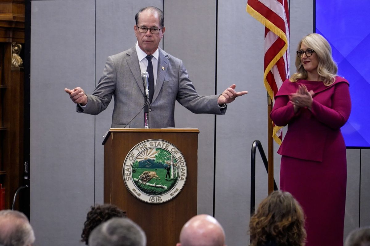 overnor Mike Braun stands at a podium with the index fingers of each hand pointing in opposite directions.