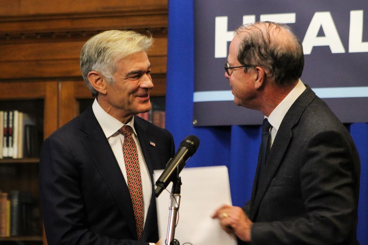 Indiana Governor Mike Braun, on the right side of the image, shakes hands and speaks with Centers for Medicare and Medicaid Services Administrator Mehmet Oz, on the left side of the image