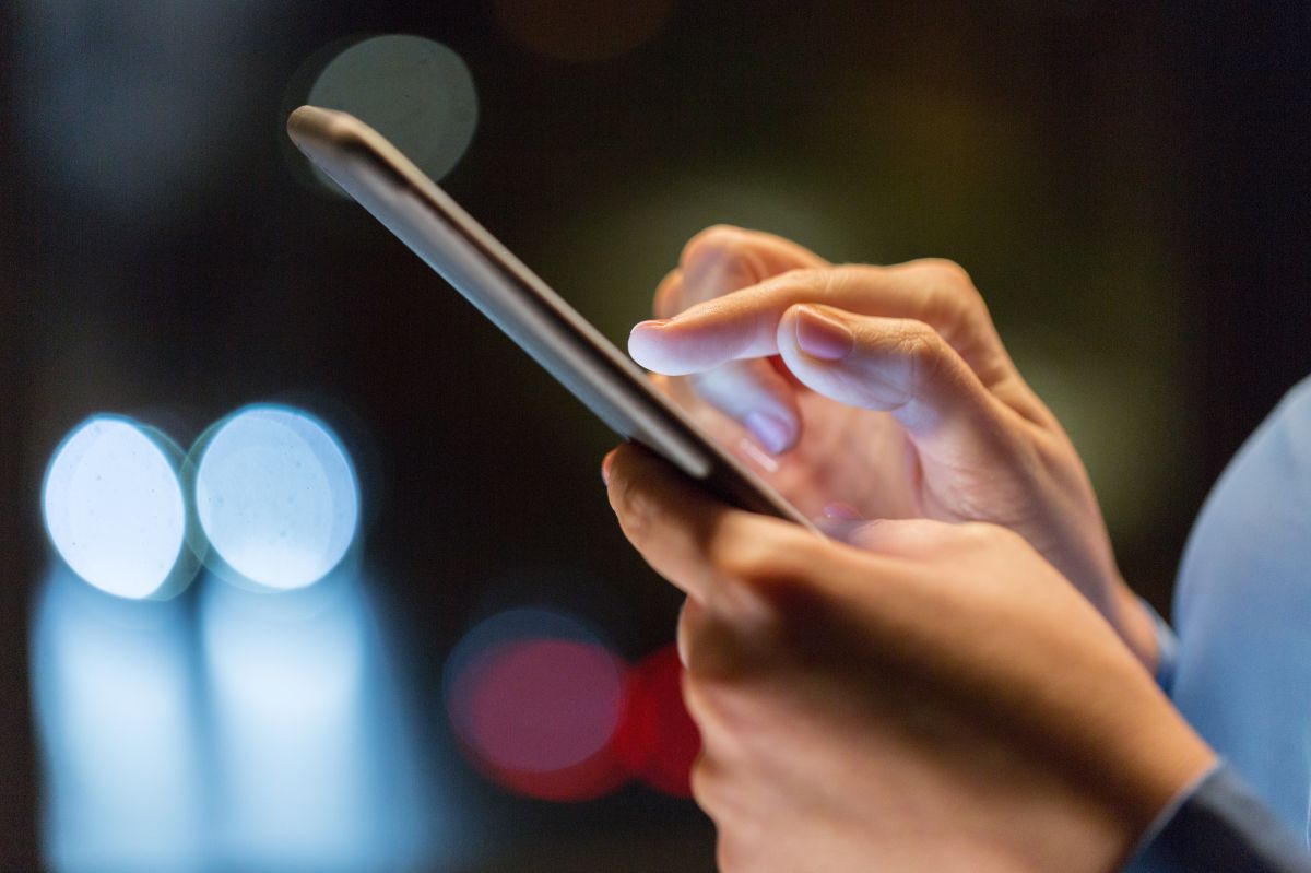 business, technology and people concept - close up of businesswoman hands with smartphone