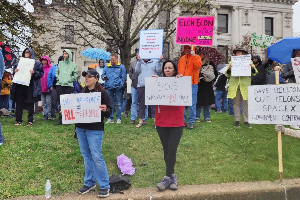 Demonstrators at the Monroe County Courthouse protesting President Donald Trump and billionaire Elon Musk.