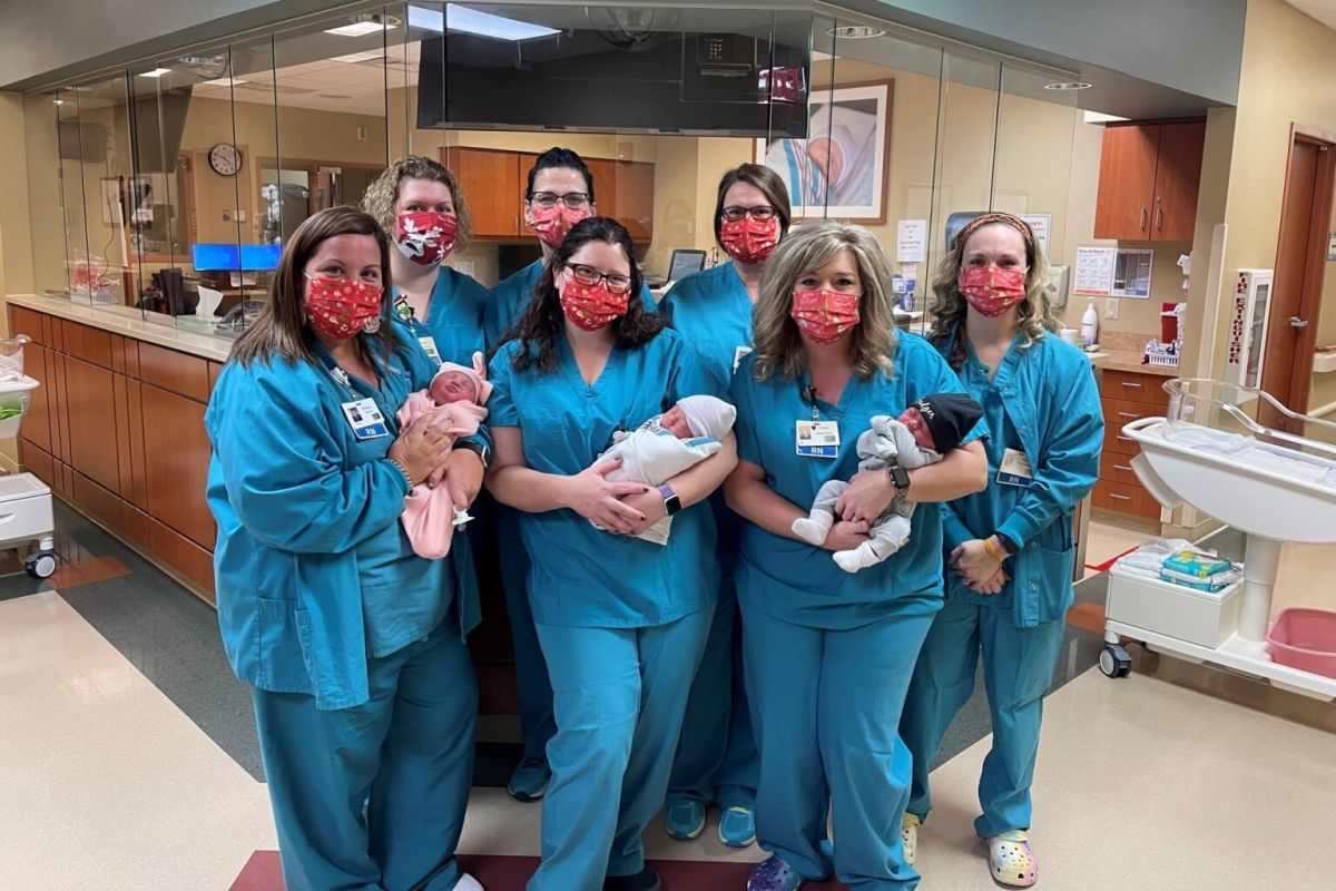 The Harrison County Hospital Maternity Center team poses with babies they cared for several years ago