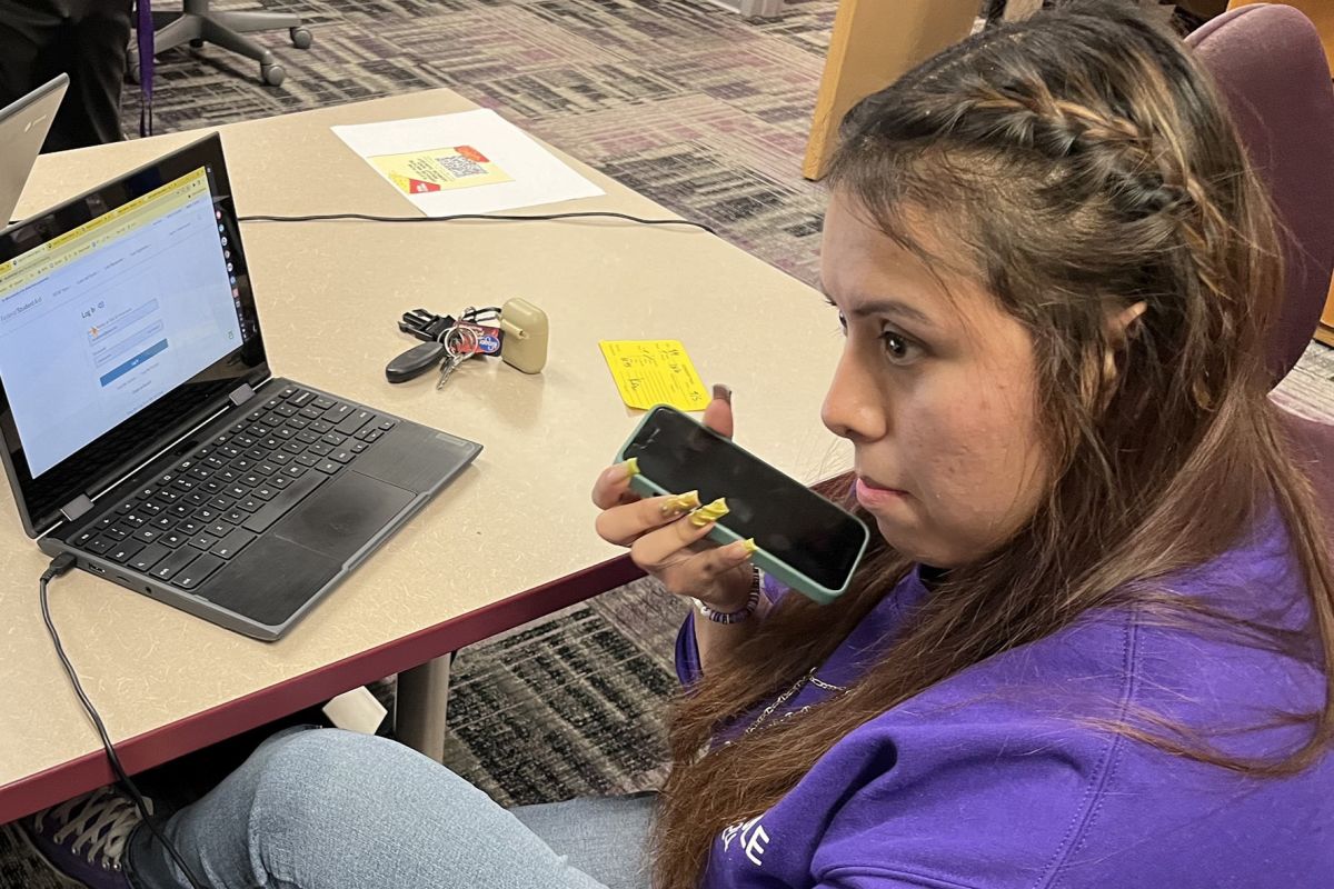 Ben Davis High School senior Isela waits on hold with the federal financial aid hotline Thursday, April 4, 2024 at the Indianapolis school. She needed help completing the new version of the Free Application for Federal Student Aid.