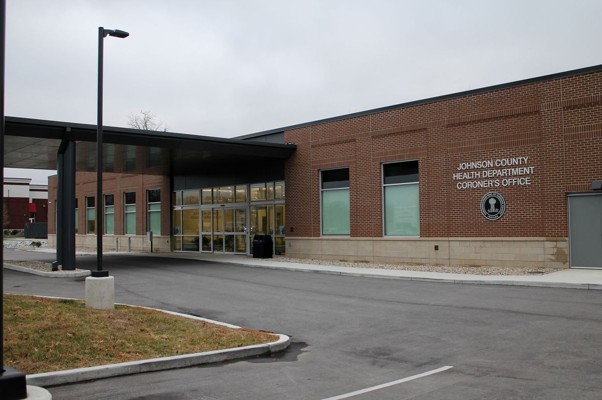 The front entrance of the Johnson County Health Department and Coroner's Office on a cloudy day.