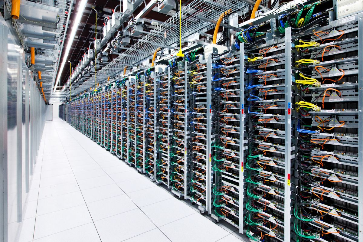 Inside a Google data center in Mayes County, Oklahoma. Rows and rows of servers sit in a bright room with white floors.