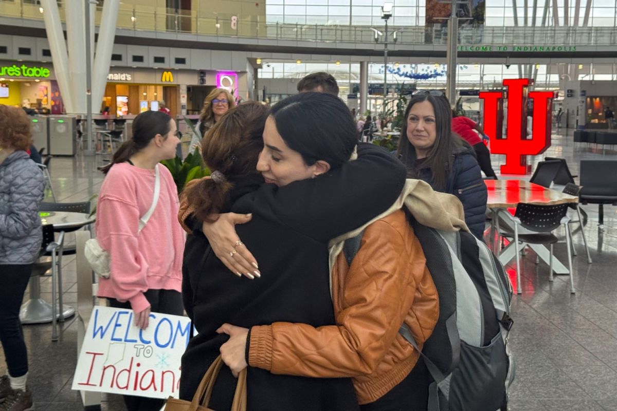Rokhsar Oria receives a hug after arriving in Indianapolis.