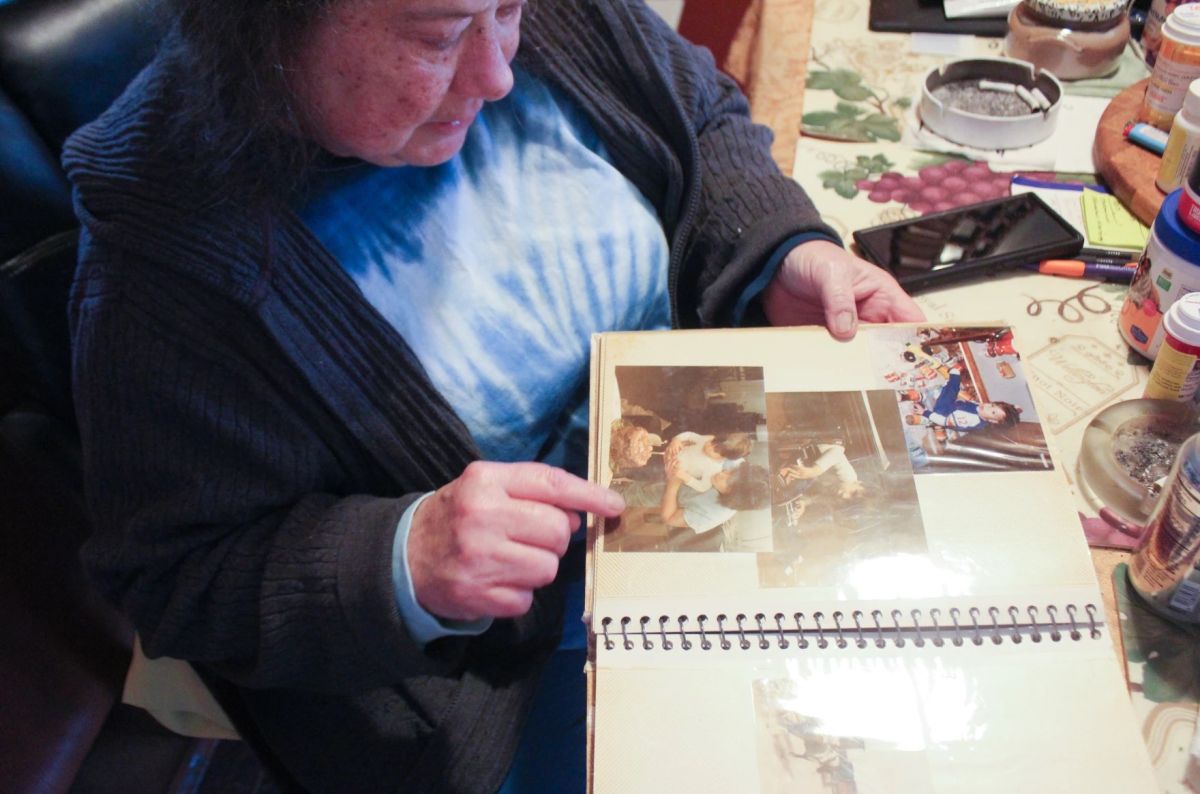 Pam Grillo points to a photo of her son, Kevin Mock, as a young child in a family album at her home in Greenwood, Ind., on Thursday, April 10. Kevin spent months in the Johnson County Jail awaiting a court-ordered competency evaluation.