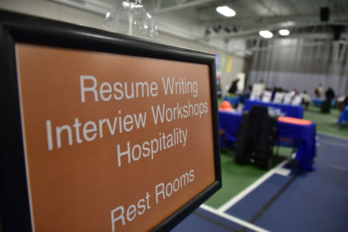 A sign reads "Resume Writing Interview Workshops Hospitality"