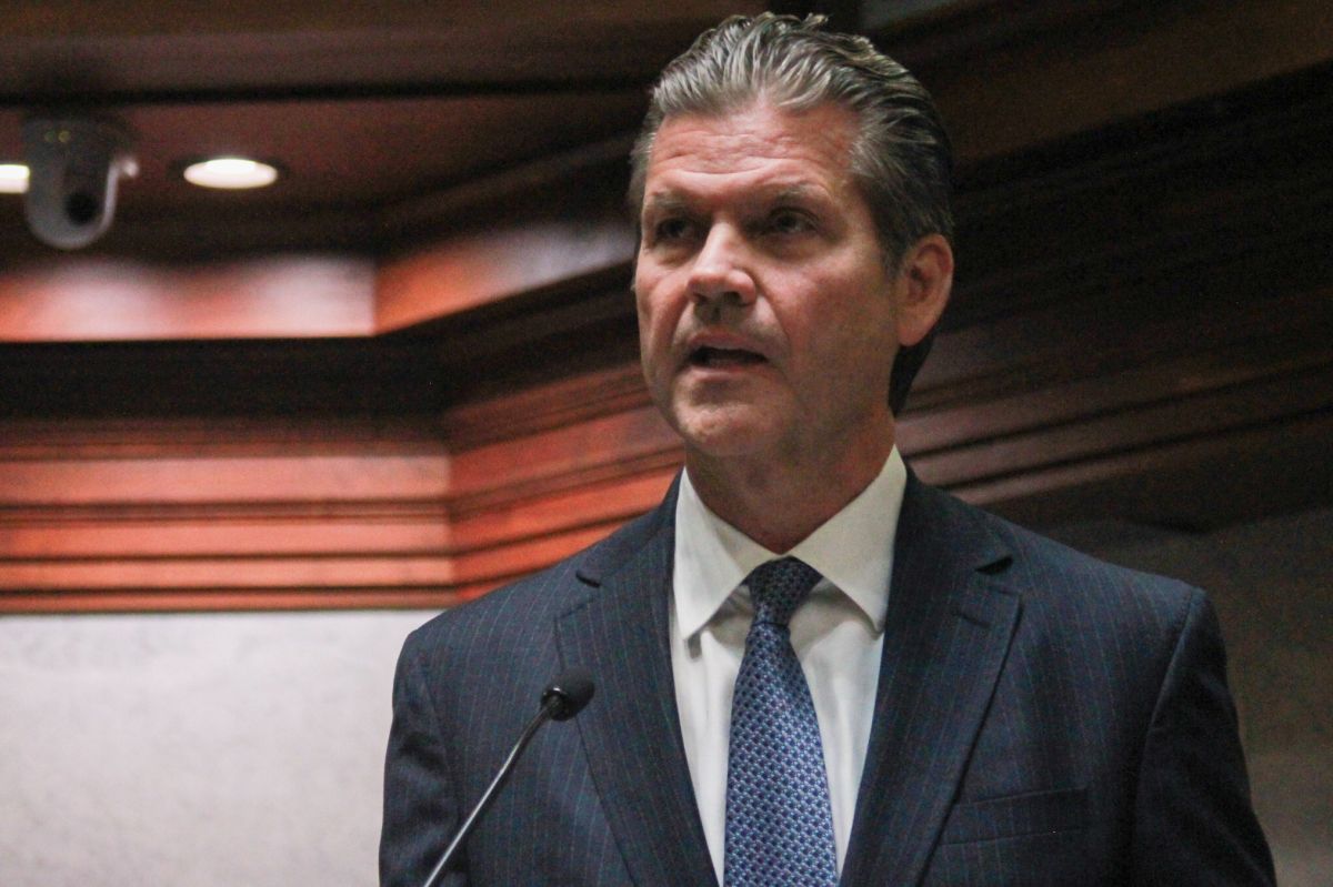 Ryan Mishler speaks into a microphone on the Senate floor. He is a White man with dark hair. He is wearing a suit and tie.