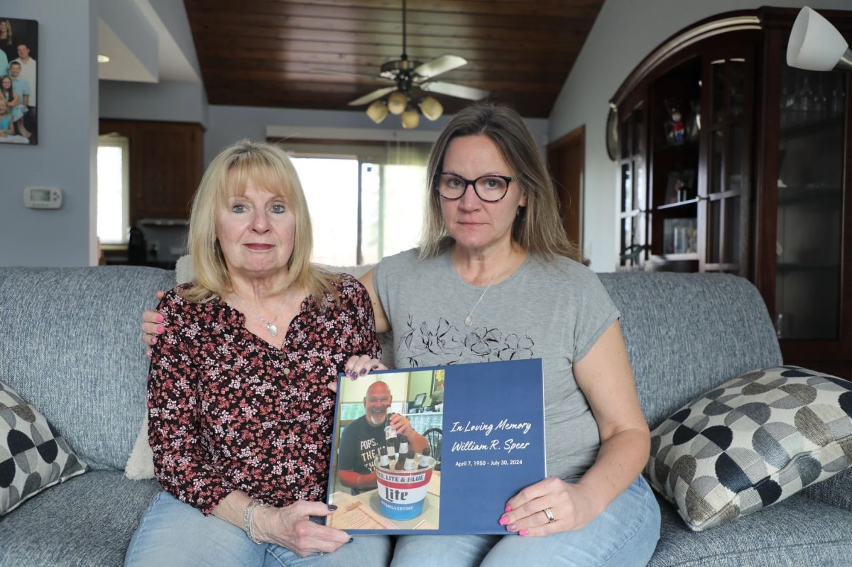 Boni Speer, left, and her daughter, Tracy Balhan, hold a photo of Bill Speer, Tracy’s father, in Aurora, Ill., on Friday, March 14, 2025.