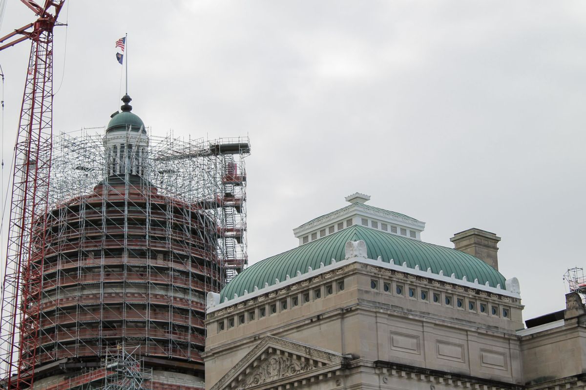 The cupola of the Indiana Statehouse is at to the left of the frame surrounded by scaffolding.