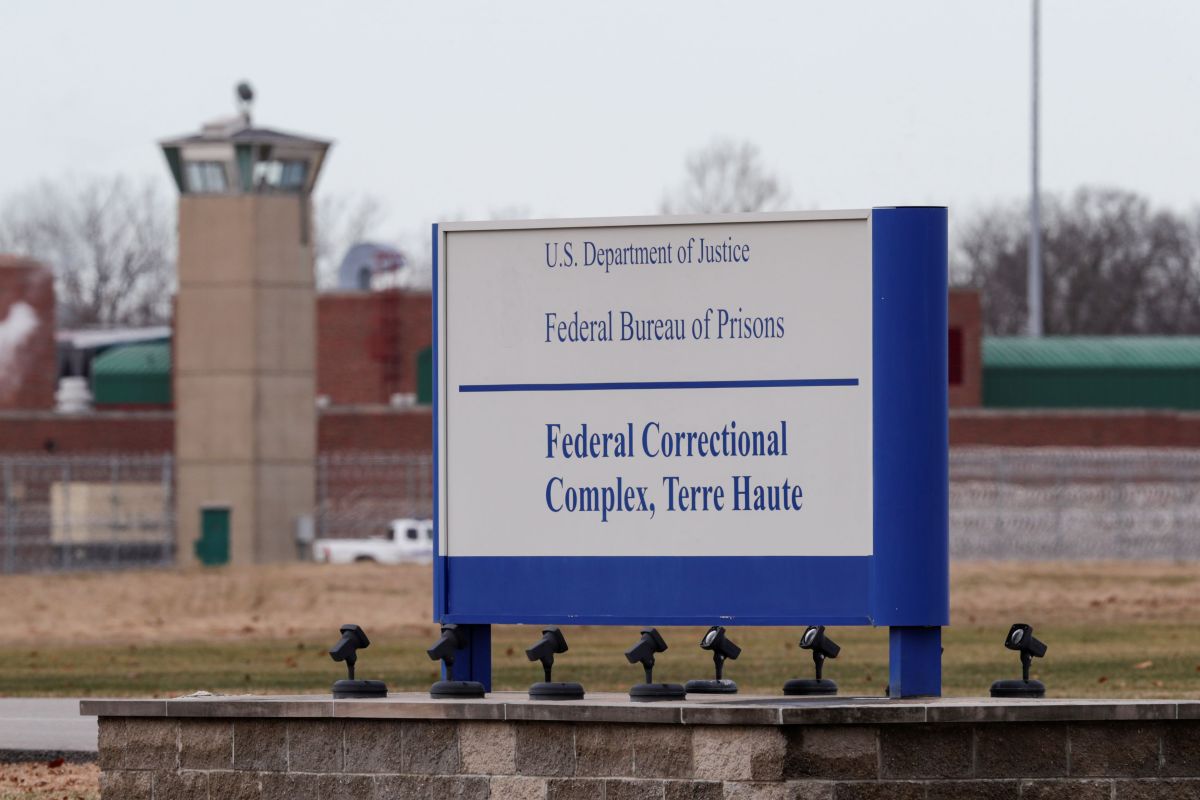 OK TO USE In this Dec. 10, 2019, file photo the guard tower flanks the sign at the entrance to the U.S. Penitentiary in Terre Haute, Ind.