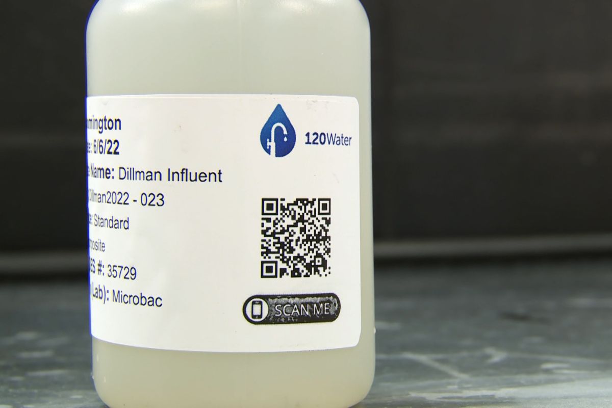 A bottle filled with wastewater is readied to be sent to a lab.