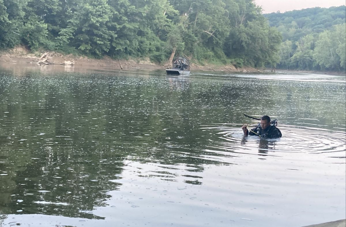 Officers search the White River in Martin County for the bodies of two juveniles Saturday.