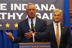 Indiana Governor Mike Braun, on the right side of the image, shakes hands and speaks with Centers for Medicare and Medicaid Services Administrator Mehmet Oz, on the left side of the image
